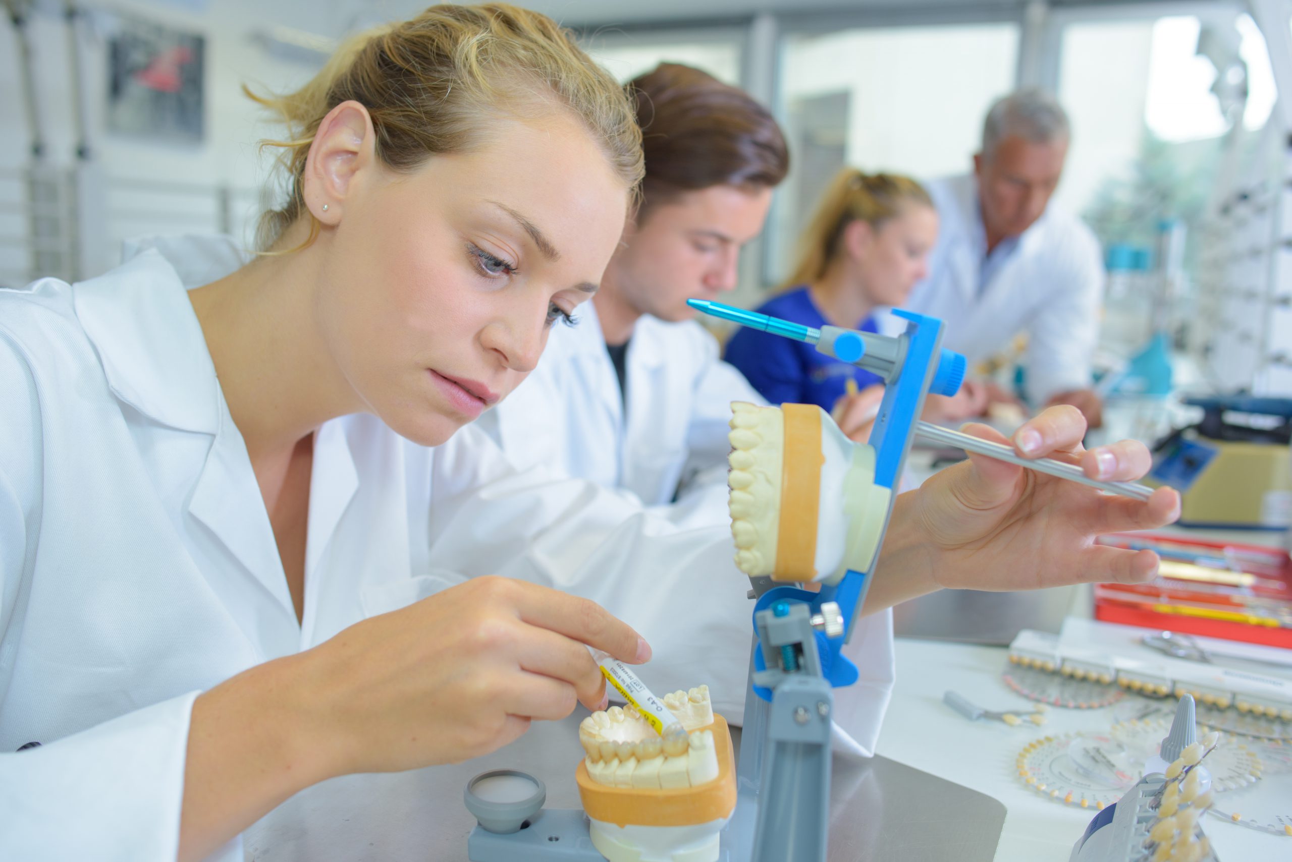 Female lab technician working on dentures